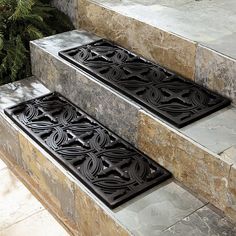 two black floor mats sitting on the steps