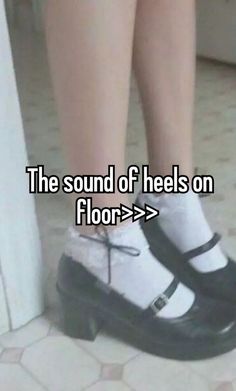 someone is standing on the floor with their feet up and wearing black and white shoes