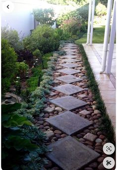 a stone path in the middle of a garden