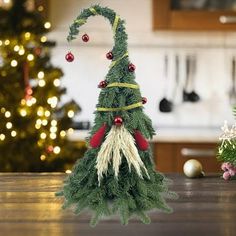 a small christmas tree sitting on top of a wooden table