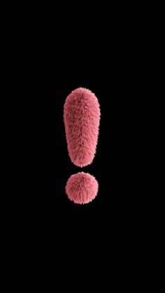 two fuzzy pink objects on a black background