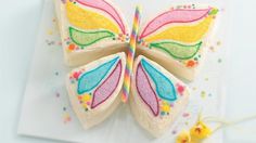 a decorated butterfly sitting on top of a white napkin