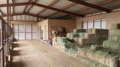 hay bales are stacked up in the barn