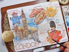 a person holding a pen and writing on a notebook with pictures of london, including the big ben clock tower