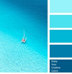 a boat floating on top of a blue ocean next to a beach with white sand