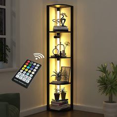 a lighted shelf with various items on it and a remote control in front of it