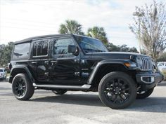 a black jeep parked in a parking lot