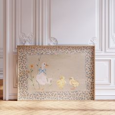 there is a painting on the wall with two ducks and one duckling next to it