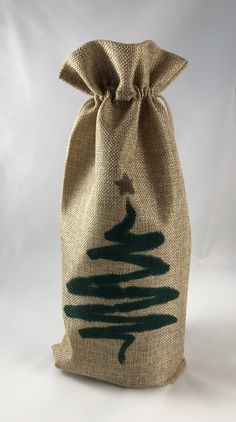 a burlock bag with a tree drawn on the front and green trees painted on the side