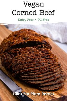 a sliced loaf of vegan corned beef on a cutting board with a knife