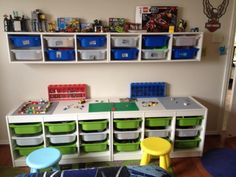 a child's playroom with toys and storage bins