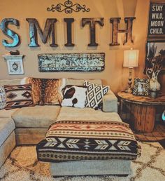 a living room filled with lots of furniture and decor on top of carpeted flooring