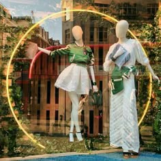 two mannequins dressed in white and green outfits stand next to each other