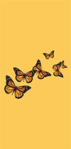 three orange butterflies flying in the air on a yellow background with space for your text