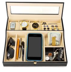 an open box containing various items such as a cell phone, watch, pen and sunglasses