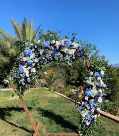 a floral arch with blue and white flowers