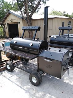 an outdoor bbq grill sitting on top of a metal cart