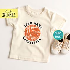 a pair of shoes and a t - shirt with the words team name basketball on it