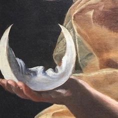 a painting of a hand holding a half moon