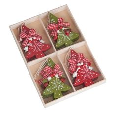 four small christmas tree ornaments in a box