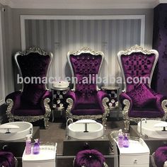 purple chairs and sinks in a room with striped wallpaper, silver trimmings