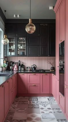 a kitchen with pink cabinets, black counters and gold accents on the ceiling is pictured in this image