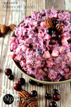 a bowl filled with fruit and nuts on top of a wooden table