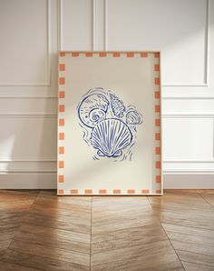 a blue and white painting sitting on top of a wooden floor next to a wall