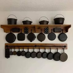 pots and pans are hanging on the wall