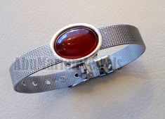 Men / women bracelet stainless steel silver color 10 mm width , silver 925 bezel red agate Aqeeq carnelian natural stone sizable Bracelet color available : Gold - silver - dark blue - Rose - Red - Black . Bracelet width : 10 mm Bracelet Fit - length : 15 - 20 Cm ( about 6 - 8 Inches ) Stone size : 13 - 18 mm Stone stripes may differ from pictured . DHL shipping in gift box . Materials : High quality plated stainless steel The bezel is silver 925 . Stone : Aqeeq - agate - red carnelian Silver Carnelian Bracelets As Gift, Silver Carnelian Bracelet As A Gift, Silver Carnelian Bracelet Gift, Silver Agate Bracelets For Gifts, Silver Carnelian Gemstone Bracelets, Silver Carnelian Gemstone Bracelet, Red Agate, Blue Rose, Stainless Steel Bracelet