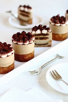 small desserts are lined up on the table