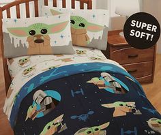 the child's bedding is decorated with star wars characters and baby yoda