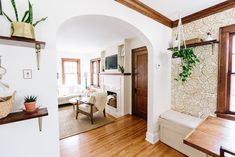 a living room with wood floors and white walls