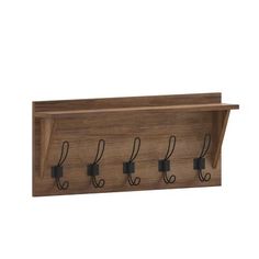 a wooden shelf with four hooks on it