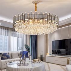 a living room filled with furniture and a large chandelier hanging from the ceiling