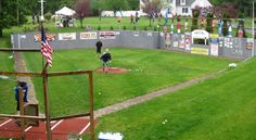 an outdoor baseball field with people on it