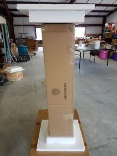 a cardboard box sitting on top of a table in a warehouse