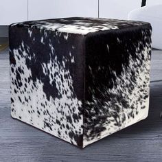 a black and white cow hide ottoman