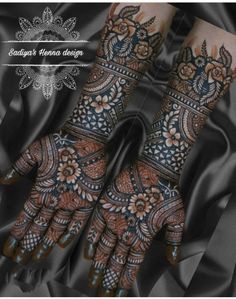 two hands with henna designs on them