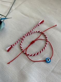 Red Bracelet With Martenitsa, Evil Eye Bracelet, Red String Bracelet, Adjustable Protect Bracelet. Handmade with love.  Set of 2 Bracelet, 1 piece of red-white cotton rope Martenitsa. Adjustable bracelet with 1 red rope and glass evil eye bead. You can wear the Red Bracelet With Martenitsa on your wrist by making a wish. Martenitsa is an old Bulgarian tradition. The Evil Eye symbolizes the jealous and envious look of others, which according to the popular belief, would have the power to cause va Adjustable Red Charm Bracelet, Adjustable Red Round Charm Bracelet, Adjustable Round Red Charm Bracelet, Red Round Beads Bracelets For Friendship, Handmade Red Adjustable Friendship Bracelets, Handmade Red Charm Bracelet As Gift, Red Round Beads Bracelet As Gift, Handmade Red Evil Eye Bracelet As A Gift, Handmade Red Evil Eye Bracelet For Gift