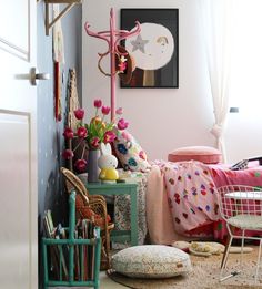 a bed room with a neatly made bed next to a chair and table in front of a window