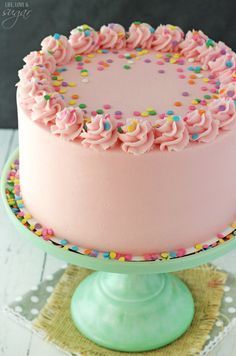 a cake with pink frosting and sprinkles