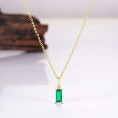 If you’ve been looking to make a bold statement with your look, our breathtaking emerald and diamond necklace could be ideal for you. Finished with a luxurious cut, exquisite emerald gemstone, and either a natural crystal or lab diamond at the very top of the necklace, it’s a unique and awe-inspiring design that’s simply impossible to ignore. Add some class to your outfit! ✦ DETAILS ✦✧ Handcrafted ✧ 2x4mm Emerald Gemstone with your choice of a natural crystal or a lab diamond✧ 14K Solid Gold Cha Green Emerald Diamond Necklace For May Birthstone, Emerald Cut Green Diamond Gemstone Necklace, Emerald Cut Green Diamond Necklace, Green Emerald-cut Diamond Necklace, Emerald Pendant Diamond Necklace For May Birthstone, Emerald Diamond Pendant Necklace For May Birthstone, Emerald Cut Green Diamond Necklace Gift, Emerald Cut Diamond Necklace As A Gift, Emerald Rectangular Pendant Necklace For May Birthstone