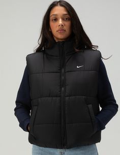 Nike Sportswear Classic Puffer Vest. Take On The Winter Chill In A Vest Designed To Add Some Warmth To Your Life. Loose Enough To Layer, Its Synthetic Fill Adds Insulation While Nike Therma-Fit Technology Helps Manage Your Body's Natural Heat To Help Keep You Warm In Cold-Weather Conditions. On Top Of That, A Water-Repellent Finish Helps Keep You Dry. So Zip It Up, Throw Your Hands In The Pockets And Get Out There! Nike Therma-Fit Technology Helps Manage Your Body's Natural Heat To Help Keep You Warm In Cold-Weather Conditions. Water-Repellent Finish Helps Keep You Dry In Wet Weather. Snap Pockets Let You Keep Your Small Items Close—or Keep Your Hands Out Of The Cold. Embroidered Swoosh Logo. 100% Polyester. Machine Wash. Imported. Model Is Wearing A Size Small. Model Measurements:height: Nike Puffer Vest, Overalls Boys, Chino Pants Women, Wwe T Shirts, Vest Designs, Casual Flat Shoes, Girls Graphic Tee, Girls Blouse, Puffer Vest