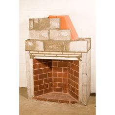 a brick fireplace with a cone on top