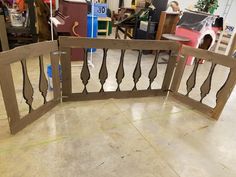 a close up of a wooden gate on the floor in a room filled with furniture