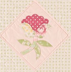 a close up of a flower on a quilted surface with polka dotty dots