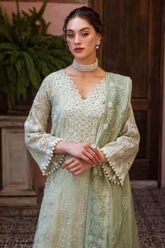 Dhara, a luxurious ensemble featuring a chikankari embroidered shirt adorned with a milky lace and pearl accents. The look is complete with a dupatta, featuring chikankari embroidery, light sequins, and pearl tassels thus adding a touch of elegance. This is a 3 pc outfit. Semi-stitched Traditional Wear With Lace Work For Eid, Elegant Pista Green Traditional Wear With Naqshi, Festive Pista Green Set With Naqshi Detailing, Elegant Long Sleeve Anarkali Set With Lace Work, Cream Sharara With Dabka For Wedding, Eid Naqshi Chinon Lawn Suit, Pista Green Wedding Kurta With Naqshi Details, Festive Cream Sharara With Dabka Details, Pista Green Wedding Kurta With Naqshi