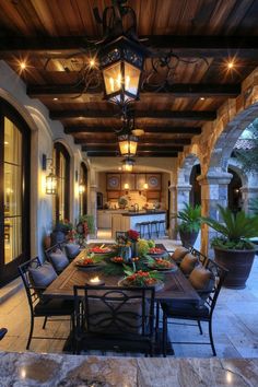 an outdoor dining area with table, chairs and potted plants on the outside patio