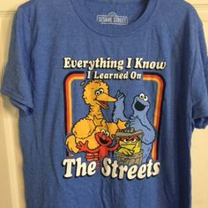 New With Tags Is A Sesame Street Funny T-Shirt, Color Blue, Size Medium, Polyester And Cotton Blend Sesame Street Clothes, Funny Blue Crew Neck Shirt, Funny Blue Crew Neck Top, Funny Crew Neck Blue Shirt, Casual Blue Shirt With Character Print, Blue Funny Fan Merchandise T-shirt, Funny Blue Fan Merchandise T-shirt, Funny Blue Screen Print Tops, Funny Blue Shirt With Graphic Print